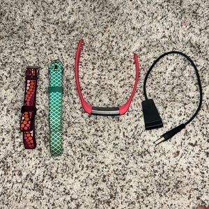 FitBit Alta activity tracker with charger and couple bands